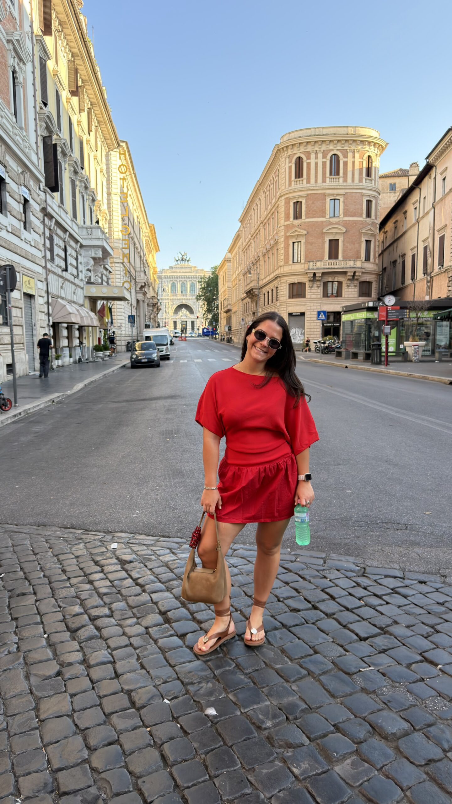 Traveler walking down a cobbled alleyway in the historic city center of Rome, Italy.